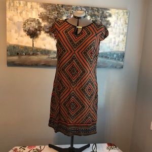 Burnt orange and navy blue patterned shift dress. Pull on style